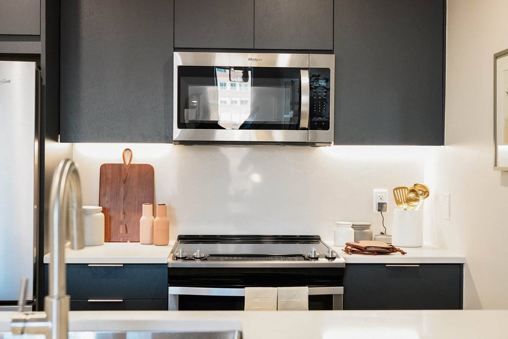 a kitchen with a stove and a microwave at The Lively, Jersey City, 07302