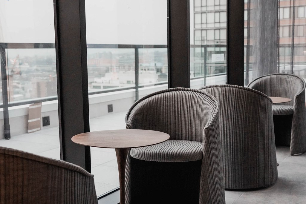 a seating area with chairs and a table in a window at The Lively, Jersey City, NJ