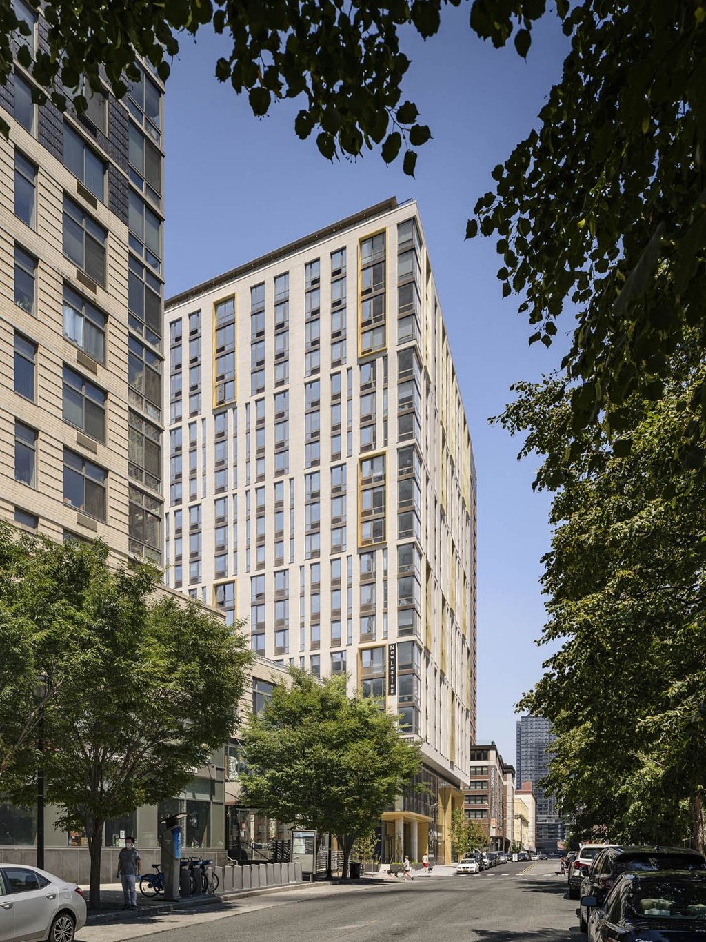 a city street with tall buildings and trees at The Lively, New Jersey, 07302