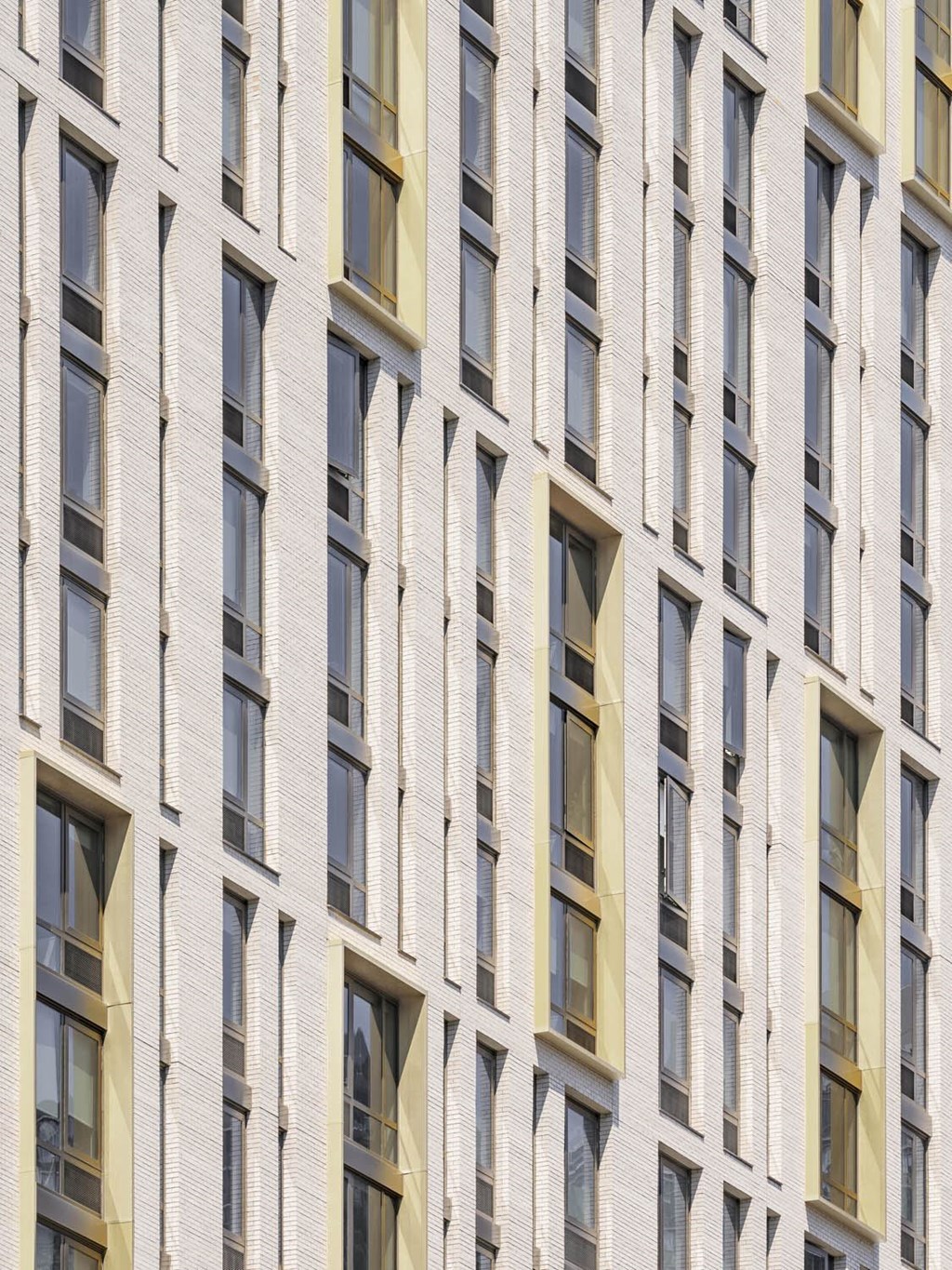 the facade of a building with many windows at The Lively, Jersey City, NJ