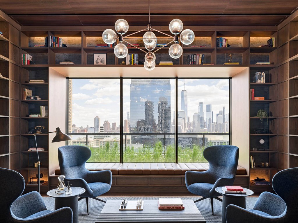 a living room with chairs and a table and a window at The Lively, Jersey City, 07302