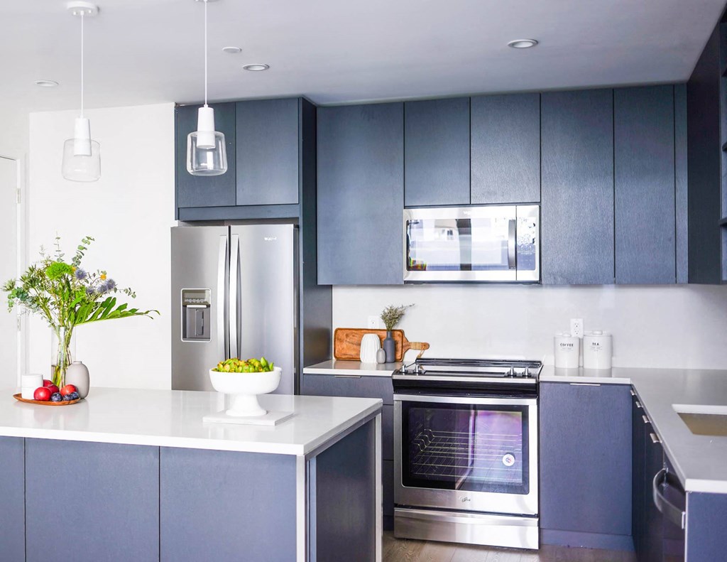 a room with a table and a vase of flowers at The Lively, Jersey City New Jersey