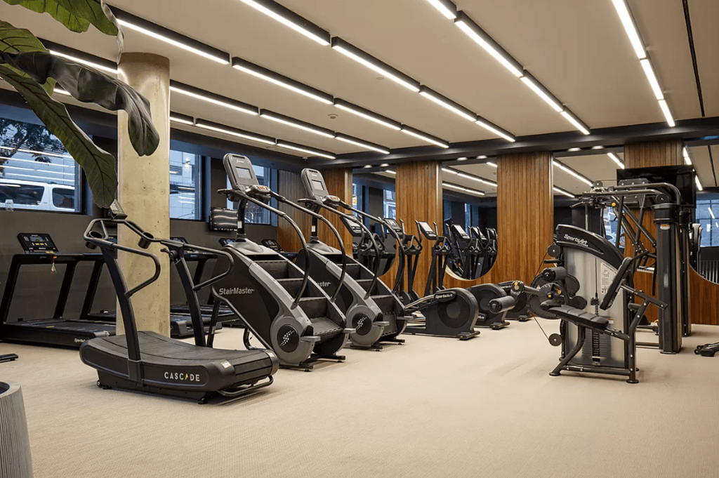 a row of exercise bikes in a gym