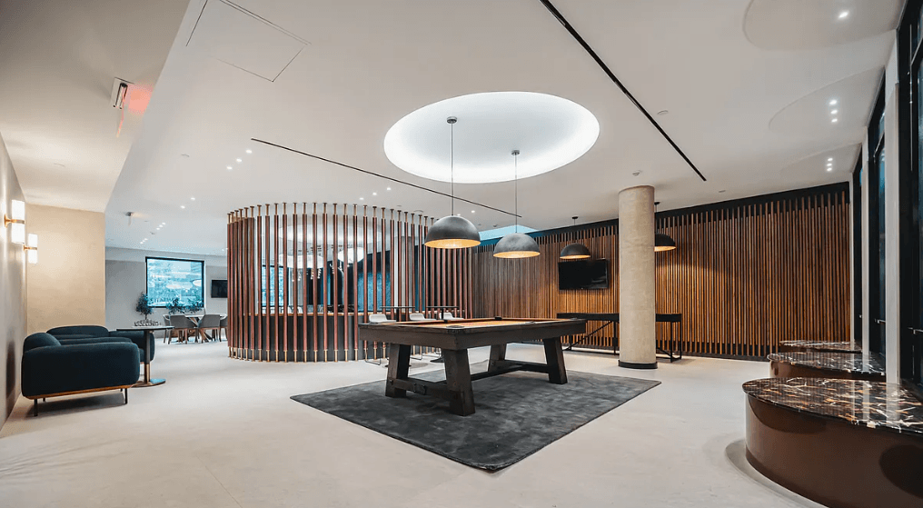 a large room with a table and chairs in the middle