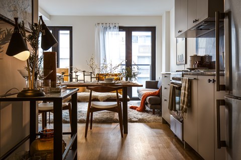 A modern kitchen with a dining table and chairs.