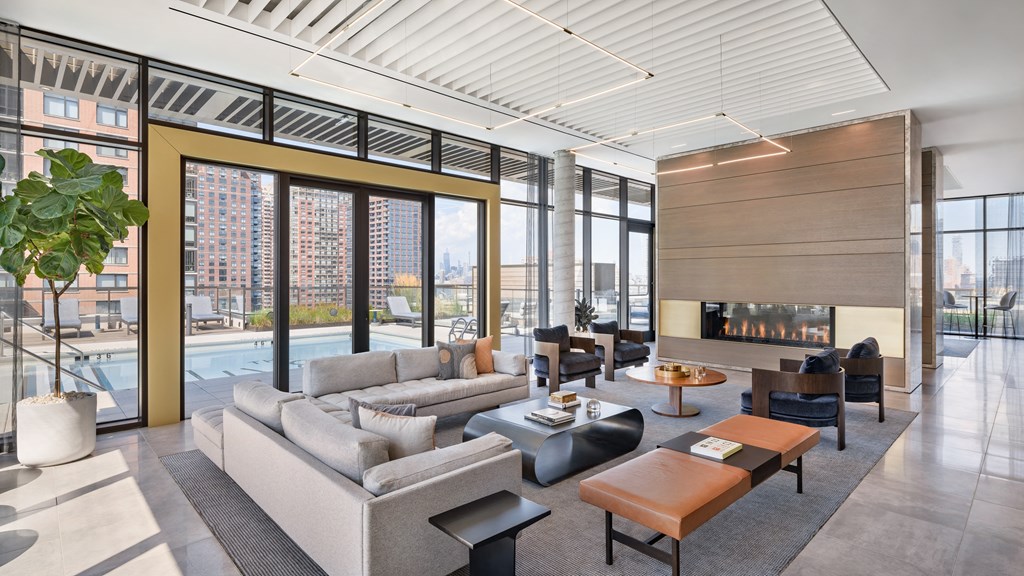 a living room with couches and tables and a fireplace at The Lively, Jersey City New Jersey