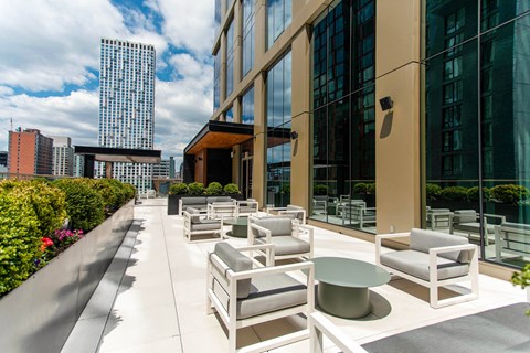 Rooftop terrace with modern seating and planters at The Paxton Apartments, New York