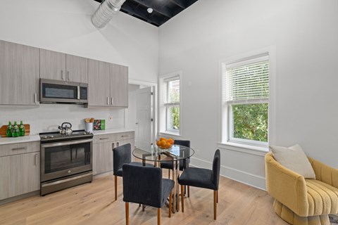 A modern kitchen with a dining table set for four.