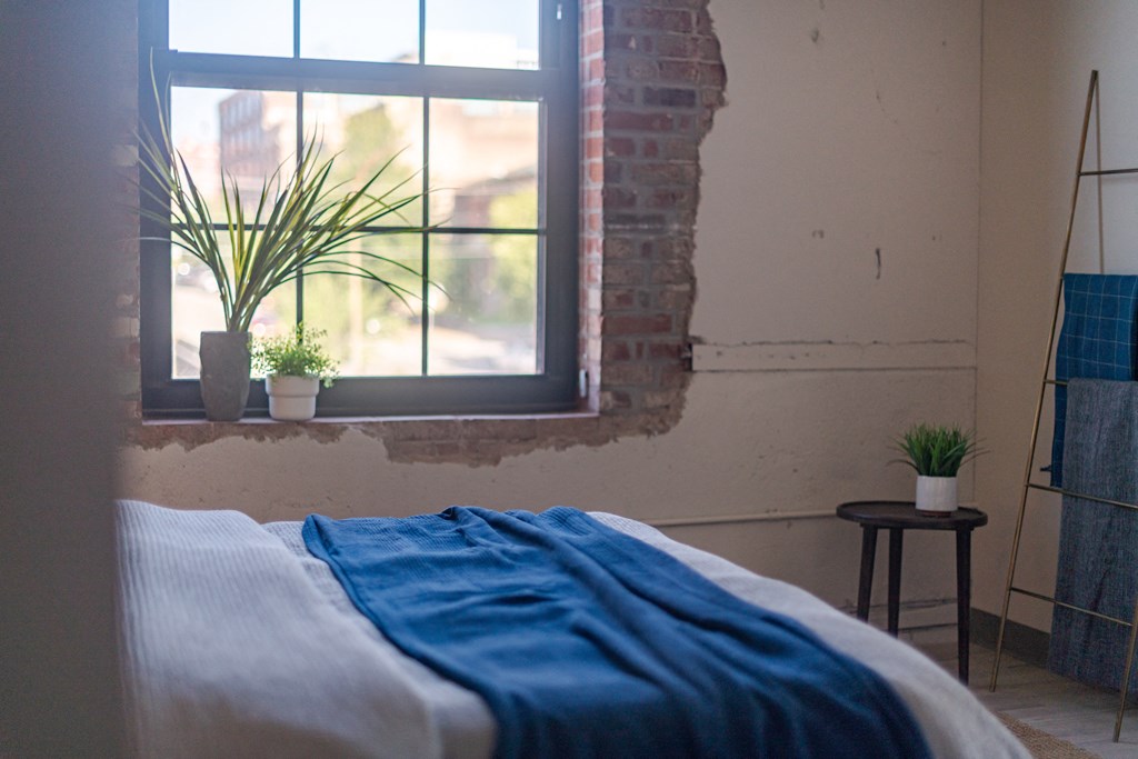a bedroom with a bed and a window at The 22 Apartments, St. Louis, 63103