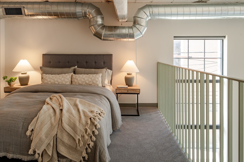 a bedroom with a bed and a window at The 22 Apartments, St. Louis, MO 63103
