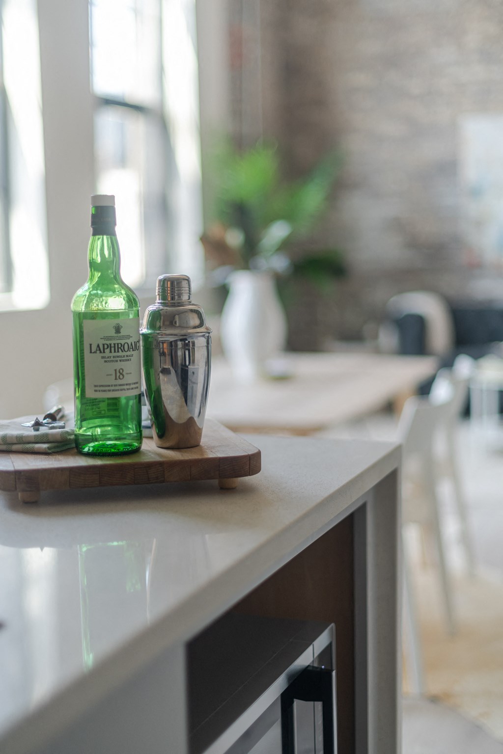 a bottle of liquor and a cocktail shaker sit on a kitchen counter at The 22 Apartments, St. Louis Missouri