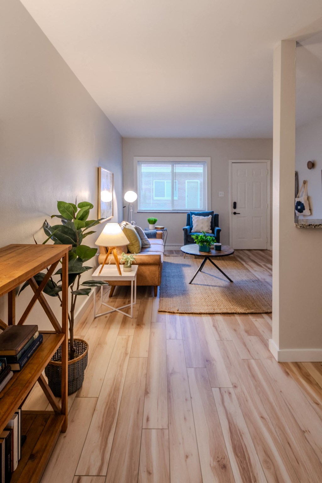 a living room with wooden floors and a couch and a table