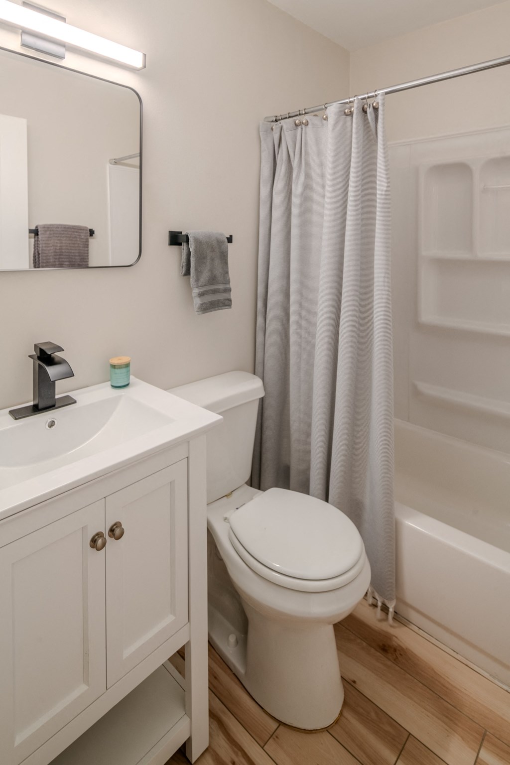 a bathroom with a shower and a toilet and a sink
