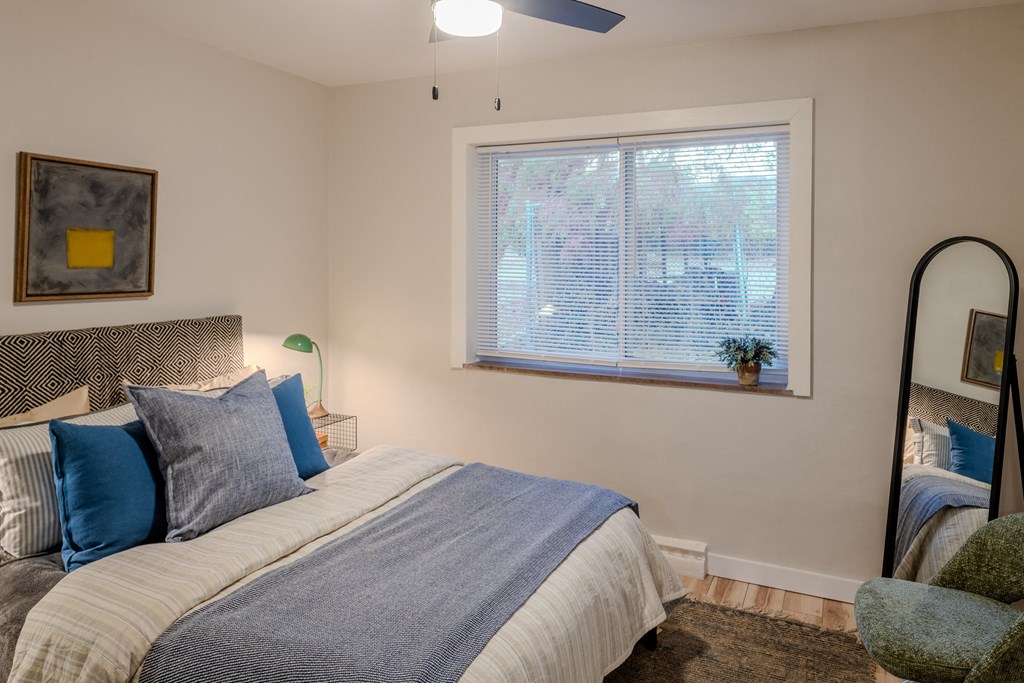 a bedroom with a large bed and a window