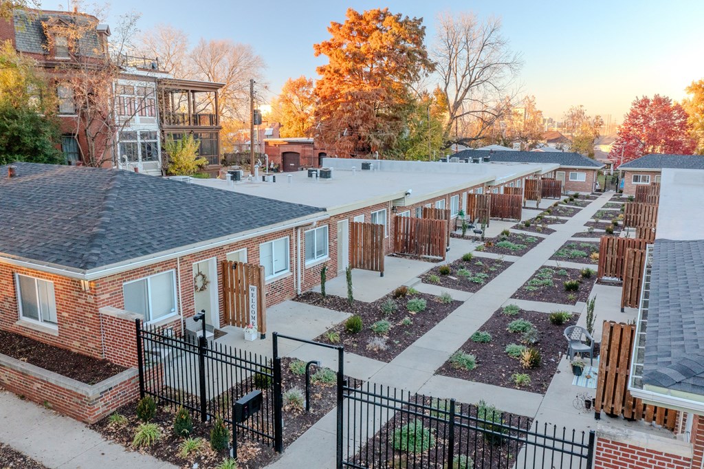 an aerial view of a community garden with brick buildings