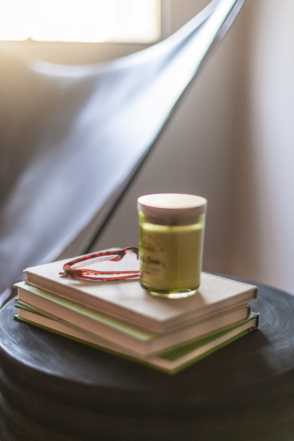 a cup of coffee sitting on top of a pile of books