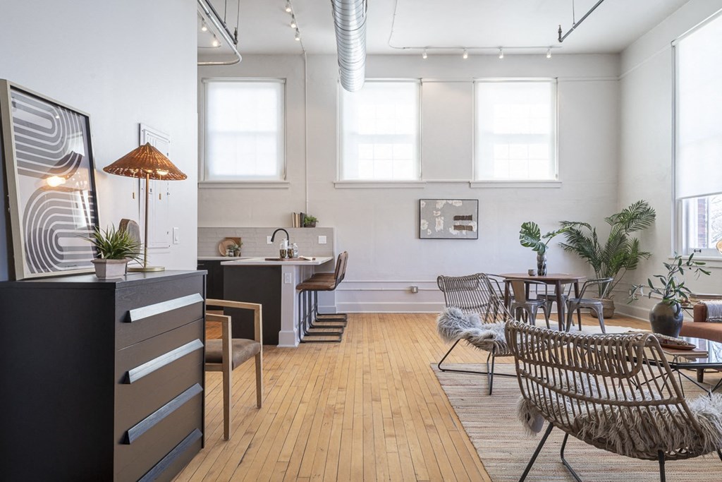 a living room with a table and chairs and a kitchen