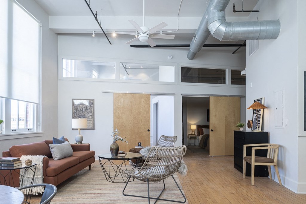 a living room with a couch and chairs and a table