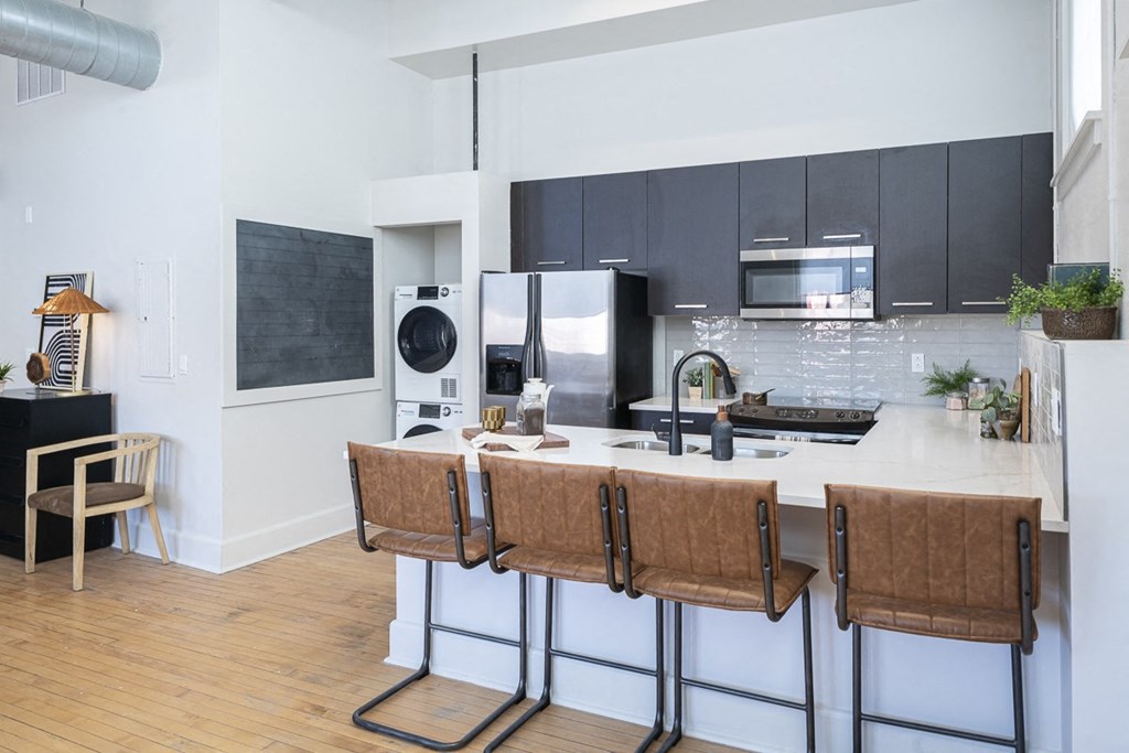 a kitchen with an island and a counter top with bar stools
