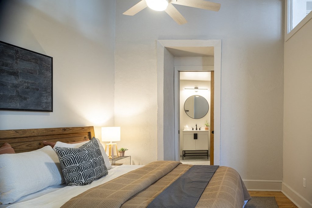 a bedroom with a bed and a triangular mural on the wall