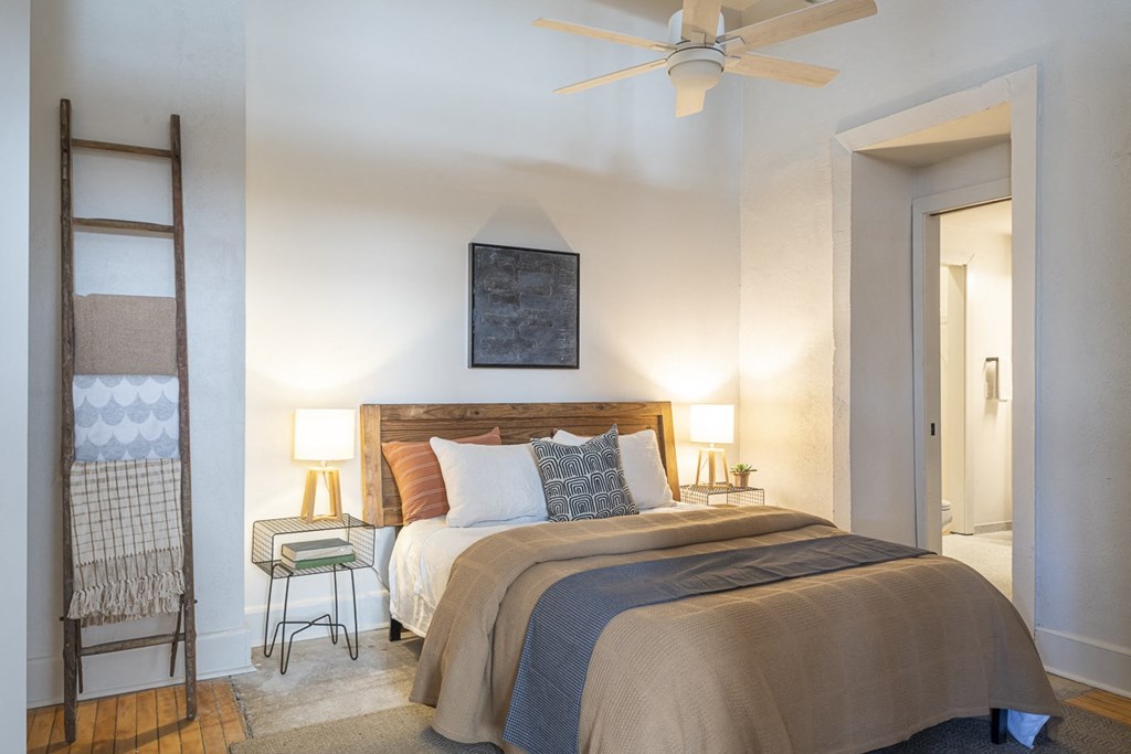 a bedroom with a bed and a ceiling fan