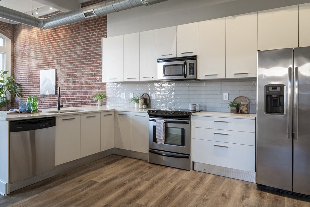 a kitchen with stainless steel appliances and white cabinets
