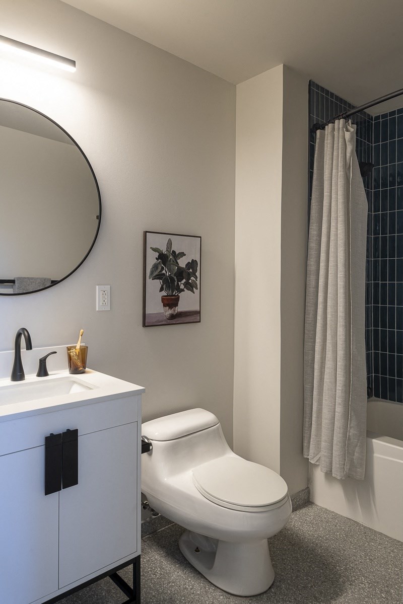 a bathroom with a toilet and a sink and a mirror