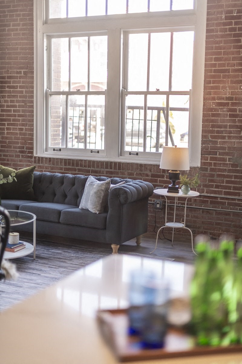 a living room with a couch and some windows
