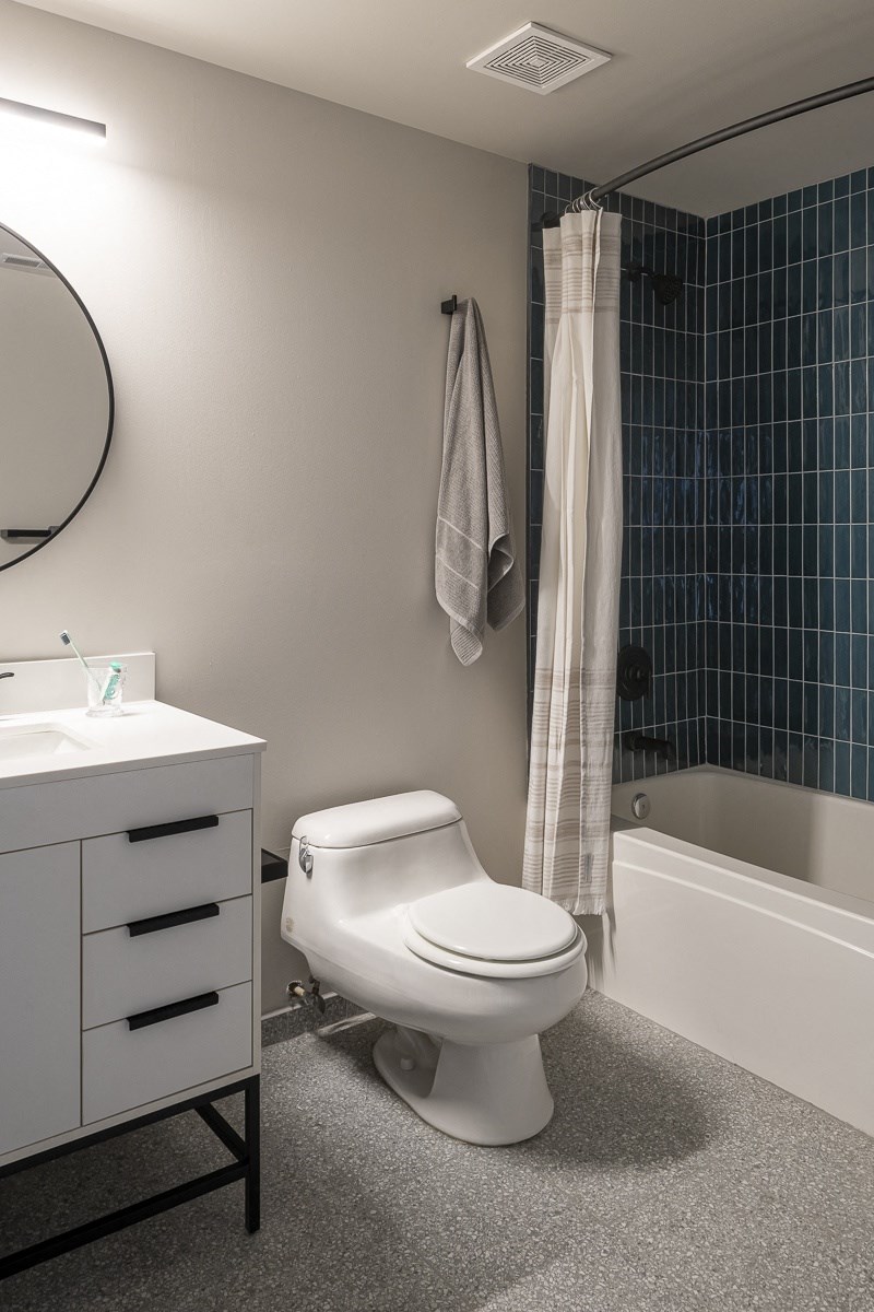 a bathroom with a toilet and a shower and a sink