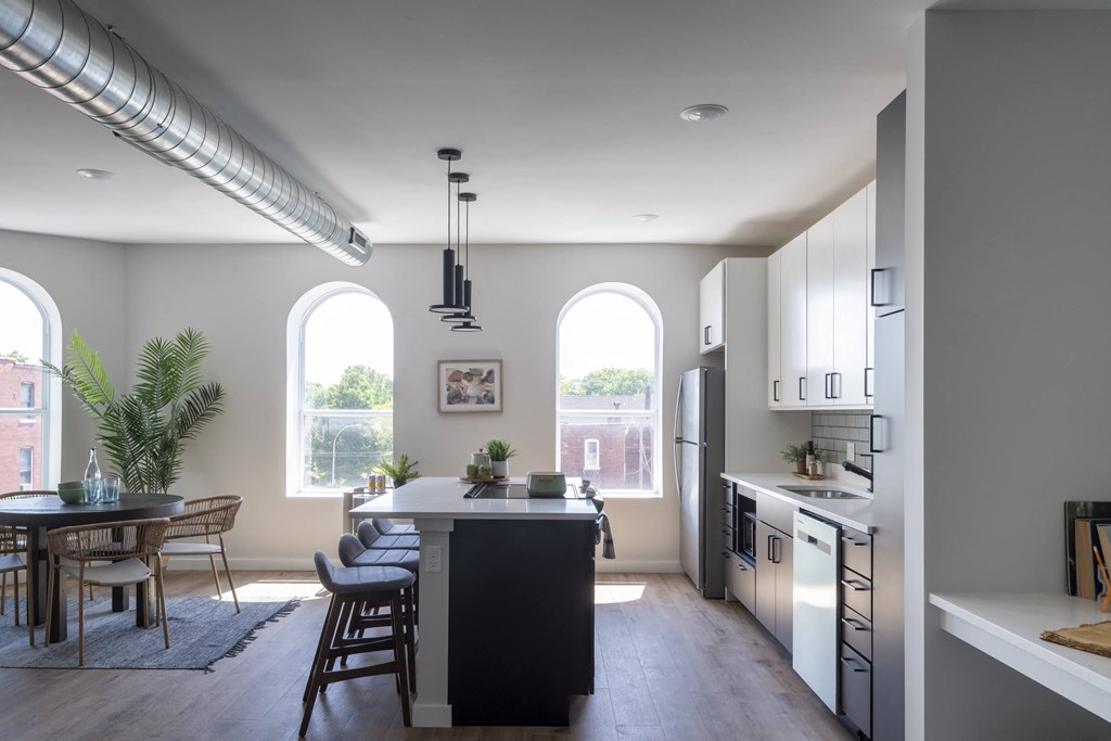a kitchen with a large island and a dining table