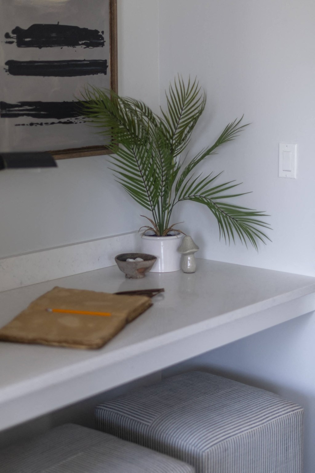 a plant on a white shelf in a room
