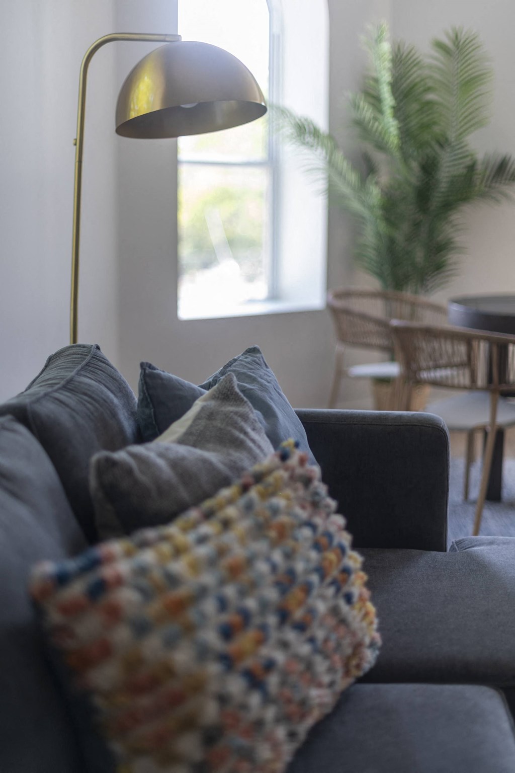 a living room with a couch and a lamp