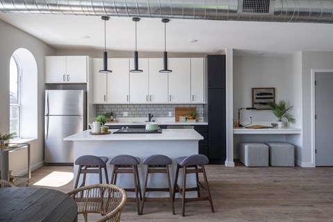a kitchen with white cabinets and a white counter top