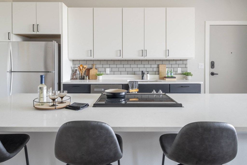 a kitchen with white cabinets and a white counter top