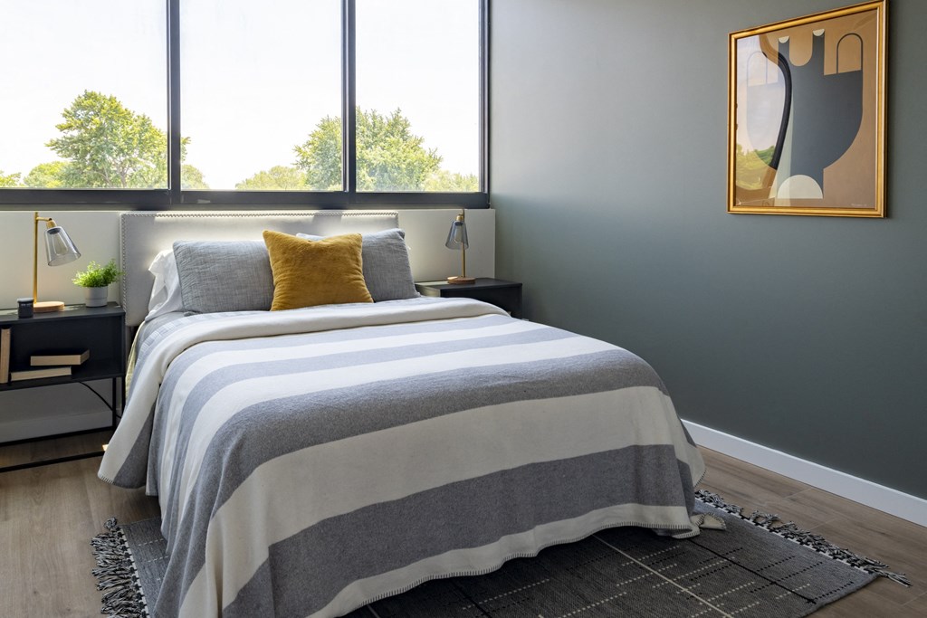 a bedroom with a bed and three windows