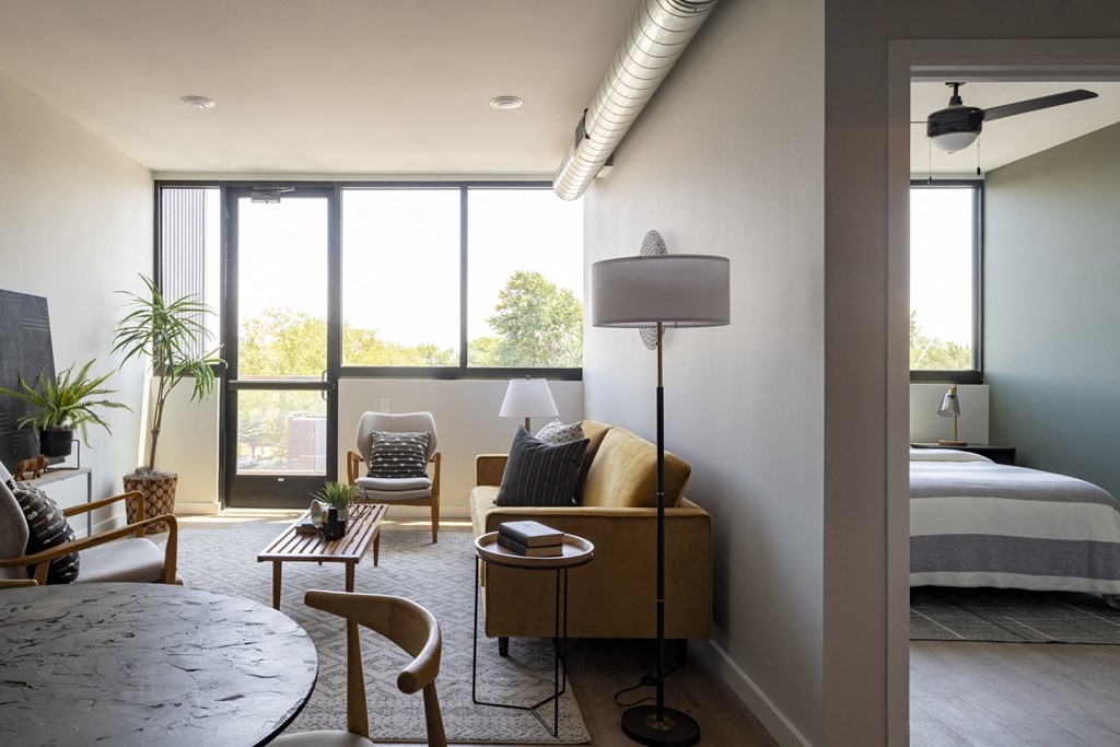a living room with a couch and a table and a bed