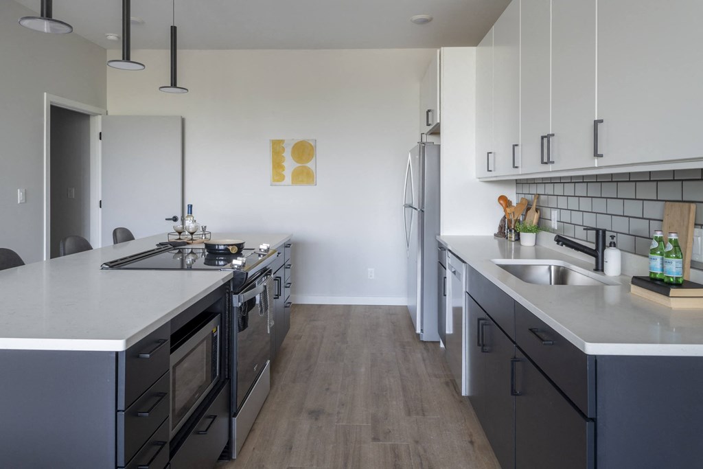 a large kitchen with stainless steel appliances and counter tops