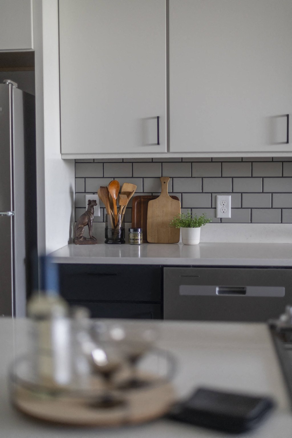 a white kitchen with black cabinets and a counter top