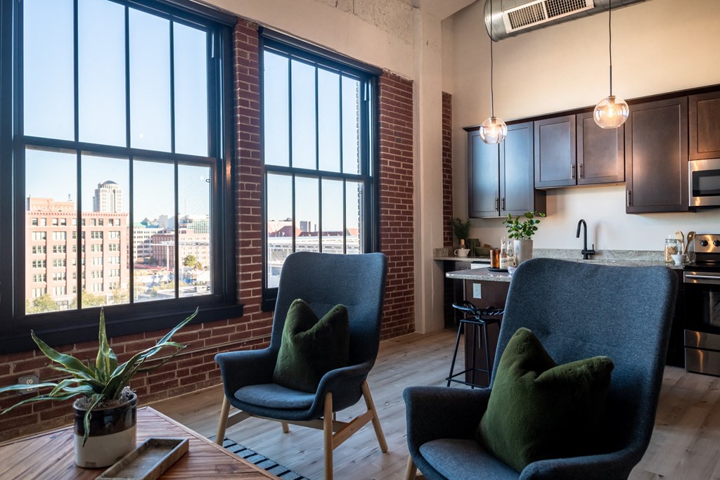 a living room filled with furniture and a large window at The 22 Apartments, St. Louis, 63103