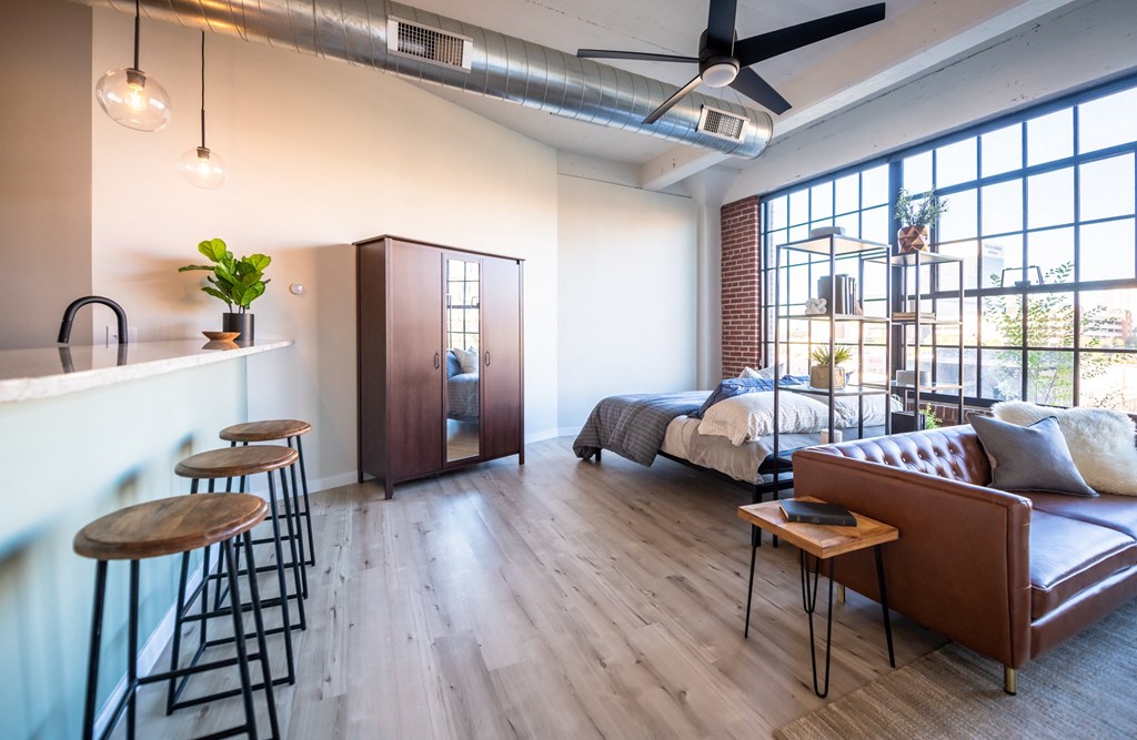 a bedroom with a bed and a bar in a room at The 22 Apartments, Missouri
