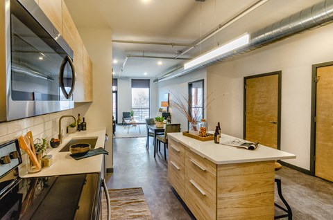 A modern kitchen with wooden cabinets and a large island.