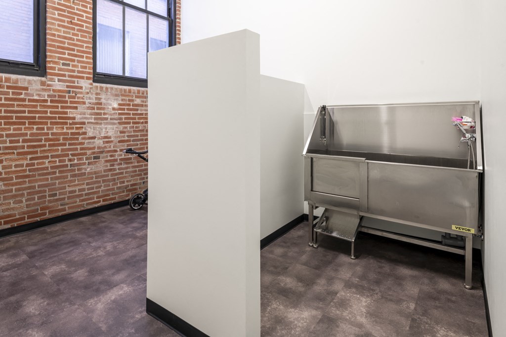 a refrigerator freezer sitting in a room next to a sink at The Draper, Missouri, 63103