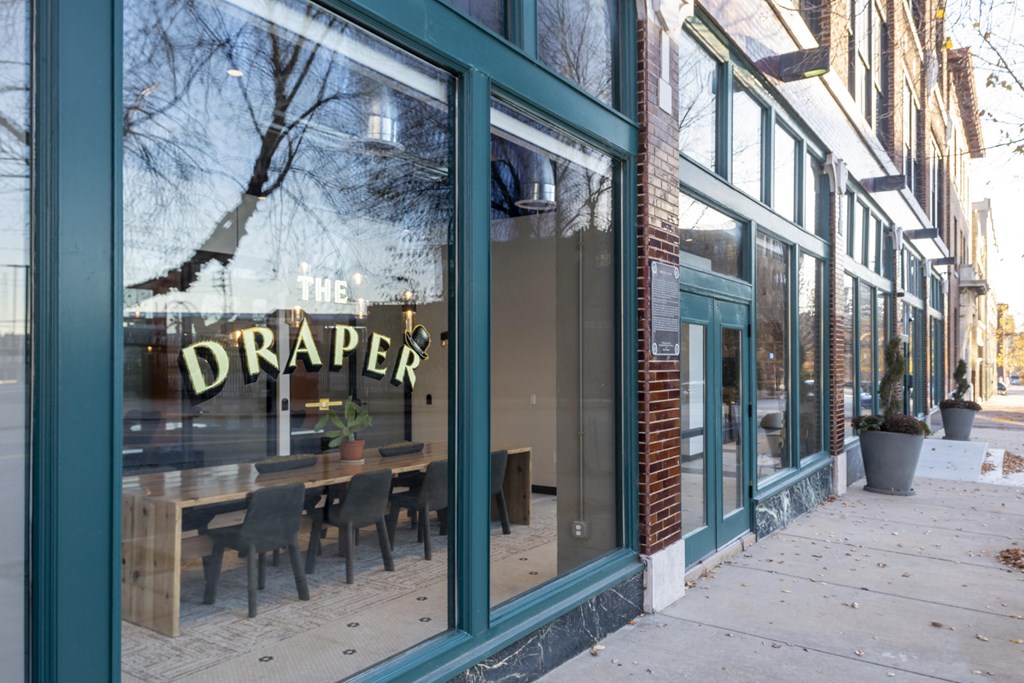 a restaurant with a large window with the drapery cafe sign in it at The Draper, St Louis, MO