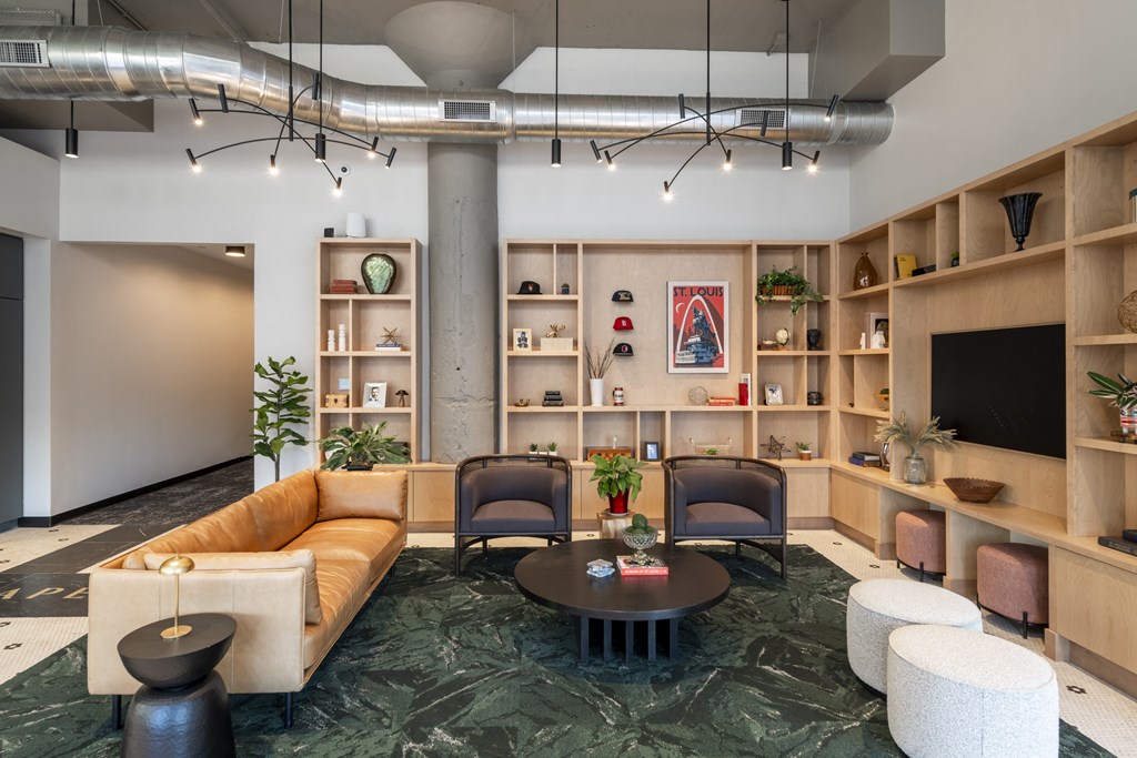 a living room with a couch and chairs and a table at The Draper, Missouri