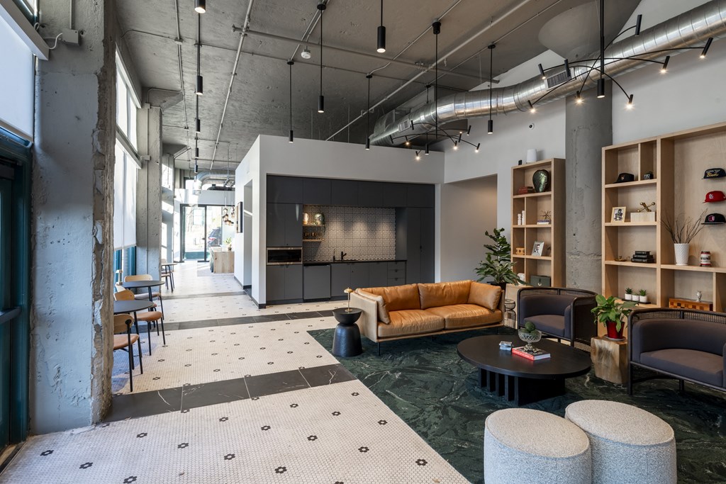 a living room with couches and chairs and a fireplace at The Draper, St Louis, 63103