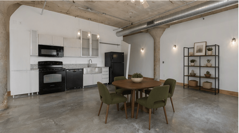 A kitchen with a table and chairs in the middle of the room.