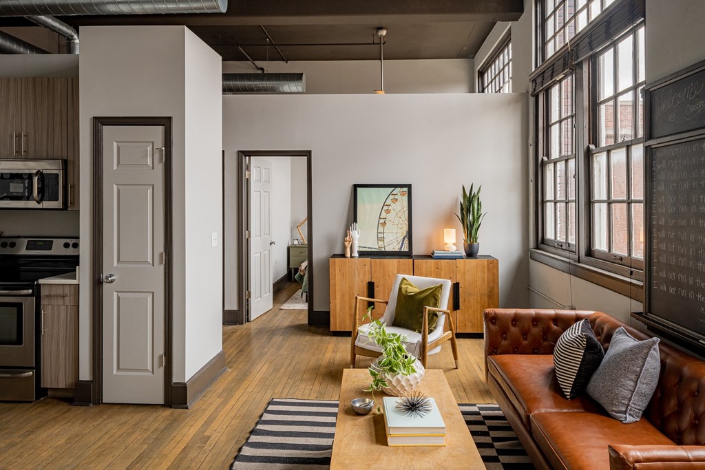 a living room with a brown leather couch and a table