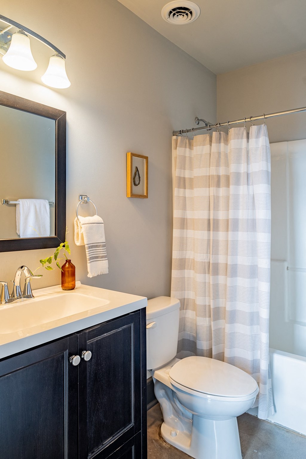 a bathroom with a toilet and a sink and a shower