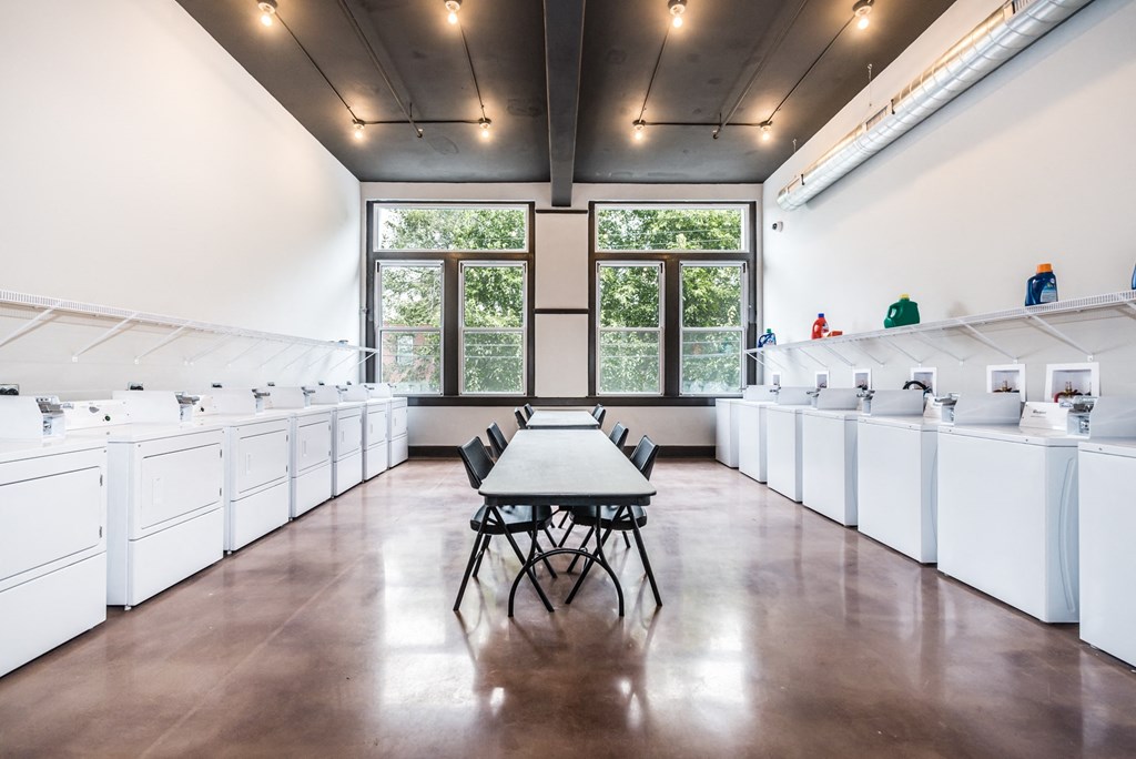 a large room with a table and chairs in the middle of it