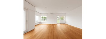 A room with wooden floors and white walls.